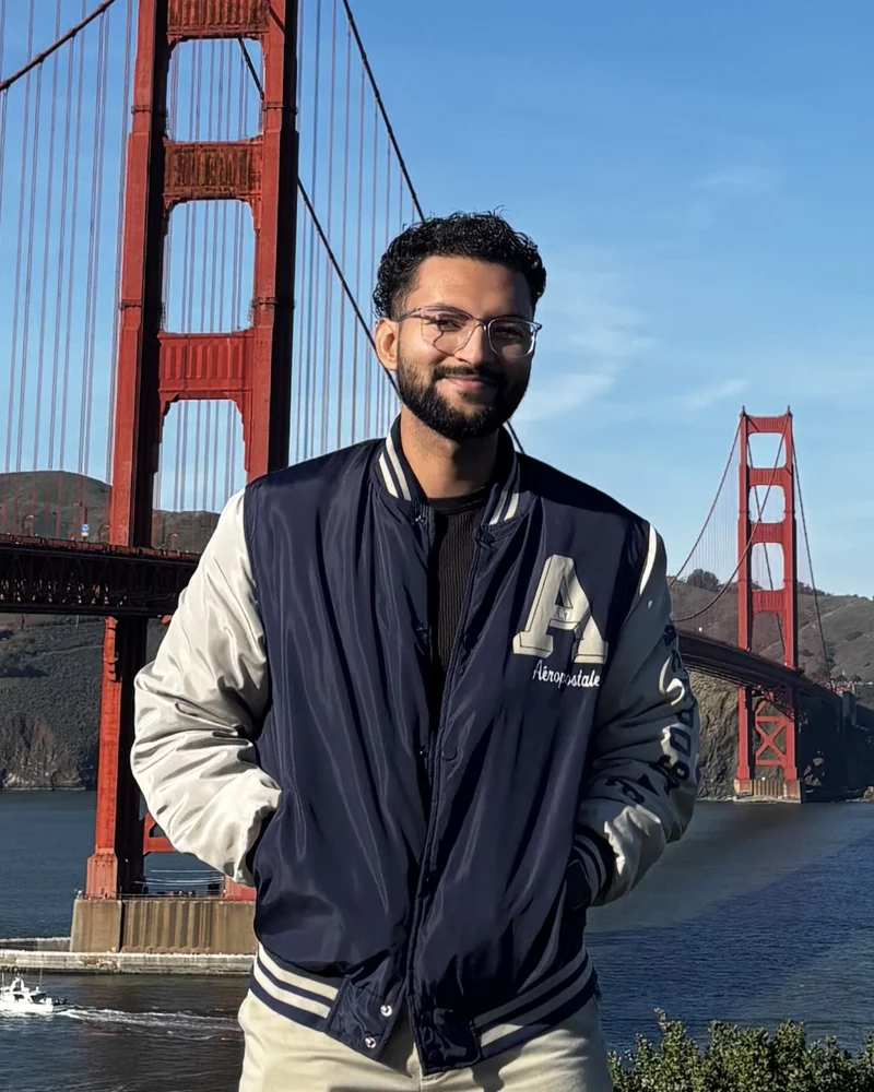 Sean Florez smiling in front of the Golden Gate Bridge